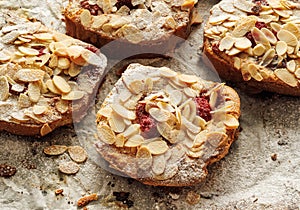 Bostock with the addition of almond cream frangipane and raspberries made of baked brioche slices, close up view.