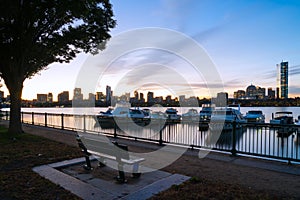 Boston skyline at sunrise with boats and harbor