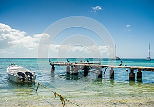 Botes anchored on the beach at Los Roques National Park photo