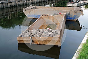 Both canal dredging boat of waste for recycling stay in the canal, waste recycling concept