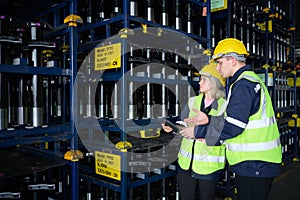 Both of employees in an auto parts warehouse, Examine auto parts that are ready to be shipped to the automobile assembly