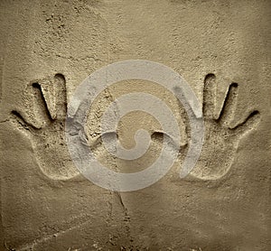 Both hands print on cement mortar wall