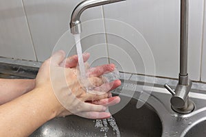 Both hands are washing their hands in the sink.Hygiene concept