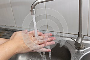 Both hands are washing their hands in the sink.Hygiene concept