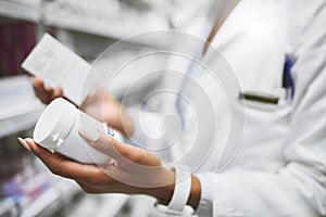 Both are important to take daily. a unrecognisable female pharmacist holding two different types of medication in each