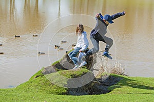 Bother and Sister Playing along lake shore