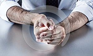 Bothered businessman hands holding fingers with tension expressing controlled exasperation