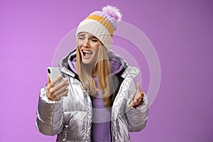 Bothered complaining dissatisfied cute blond girl yelling stupid smartphone standing unhappy recording audio message