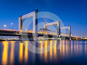 Botlek bridge, Rotterdam, Netherlands. View of the bridge at night. Road for cars and railroad transport.