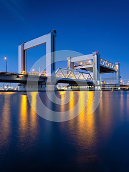 Botlek bridge, Rotterdam, Netherlands. View of the bridge at night. Road for cars and railroad transport.