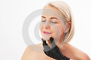 Botox injection concept: Closeup portrait of a beautiful middle age woman and doctor hands isolated on white background. Collagen