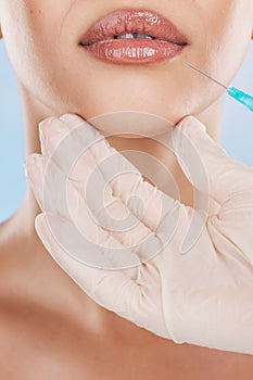 Botox, surgery and lips with a woman getting an injection in her mouth for beauty, skincare and medicine in studio on a