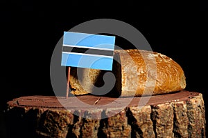 Botswana flag on a stump with bread