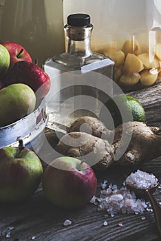 Bottle of apple cider vinegar on rustic background