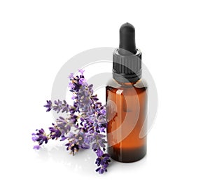 Bottle with aroma oil and lavender flowers on white background