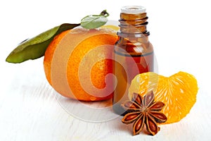 Bottle of aromatic essence and fresh orange photo