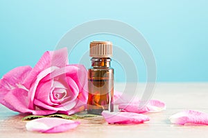 Bottle with aromatic oil and pink rose