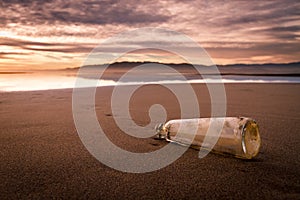 Bottle on the beach with important message photo