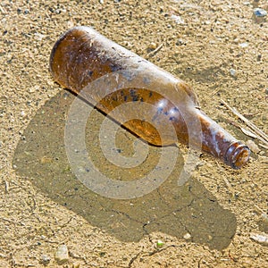 Bottle of beer glass abandoned on the gound photo