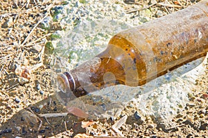 Bottle of beer glass abandoned on the gound photo