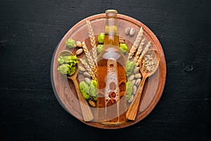 A bottle of beer, hops and grain.