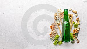 A bottle of beer, hops and grain. Top view