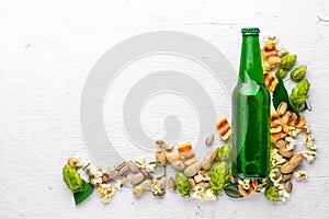 A bottle of beer, hops and grain. Top view