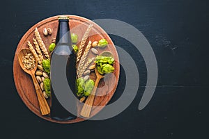 A bottle of beer, hops and grain.