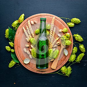 A bottle of beer, hops and grain. Top view.