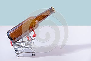 Bottle of beer in tiny shopping trolley
