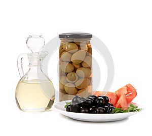 Bottle and bowl of olives with vinegar.