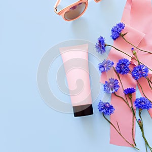 Bottle for branding and label. Mockup / 3d model of pink squeeze bottle plastic tube with black cap, blue flowers, pink ribbons