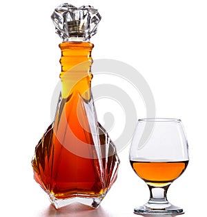 Bottle of brandy and a glass on a table