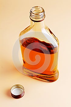 A bottle of brandy on a homogeneous background