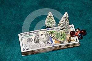Bottle Brush Christmas Trees on top of USD Hundred Dollar Bills