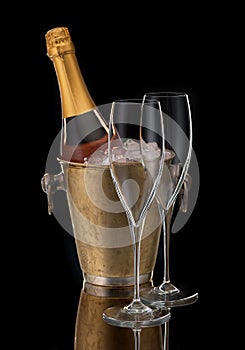 Bottle champagne in bucket and two glasses,