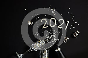 A bottle of champagne, Figures 2021. Christmas or New Year background, plain composition made of Xmas decorations and