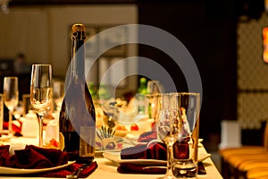 Bottle of champagne and flute on a formal table