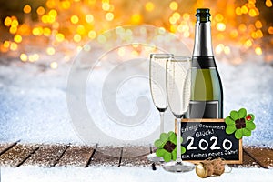 Bottle of champagne with glasses cork and blackboard german greeting frohes neues jahr 2020 greetings english translation: happy
