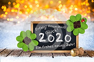 Bottle of champagne with glasses cork and blackboard german greeting frohes neues jahr 2020 greetings english translation: happy