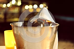 Bottle of champagne in ice bucket during romantic dinner