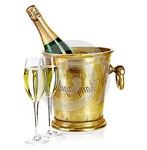 Bottle of champagne in ice bucket with stemware photo
