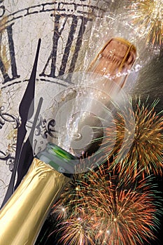 Bottle of champagne with popping cork at new years 2017