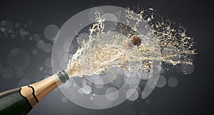 Bottle of champagne splashing upwards