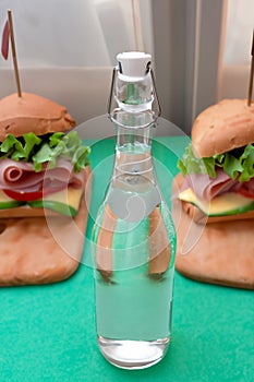 Bottle with clear water and sandwiches ready for a mid day lunch