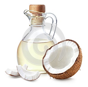 Bottle of coconut oil and half of coconut fruit on white background