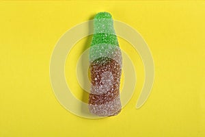 Bottle coke candy on yellow background