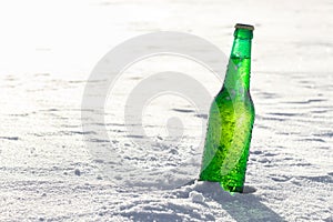 Bottle of cold beer on the snow.