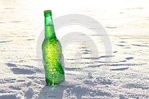 Bottle of cold beer on the snow