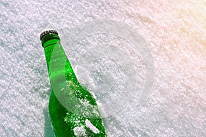 Bottle of cold beer on the snow.